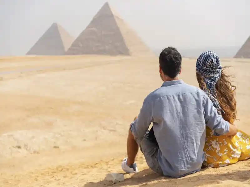 Couple enjoying Giza Pyramids View Couple enjoying Giza Pyramids View