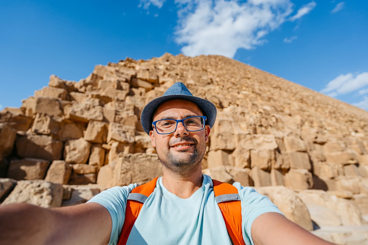 Taste of Egypt Jordan Tours a man taking selfie in front of the Pyramids of Giza, Taste of Egypt Jordan Tours
