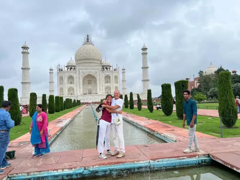 Taj Mahal older-couple-embracing-in-front-of-the-taj-mahal-with-its-reflecting-pool-and-gardens-agra-india